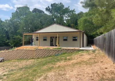 a house under construction with trees in the background