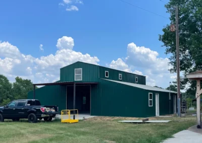 a green building with a truck parked outside