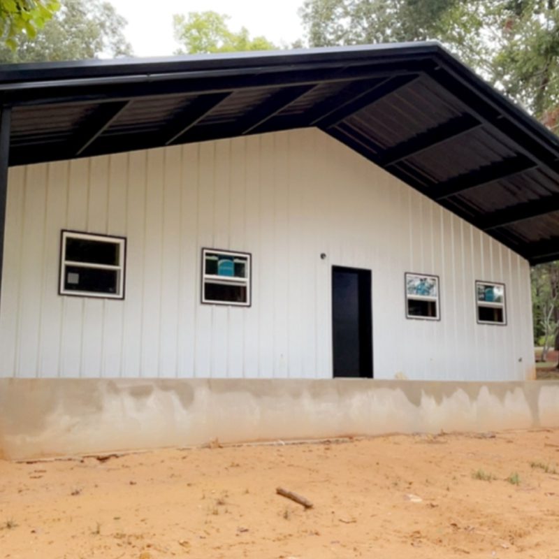 A small white building with black trim and windows.